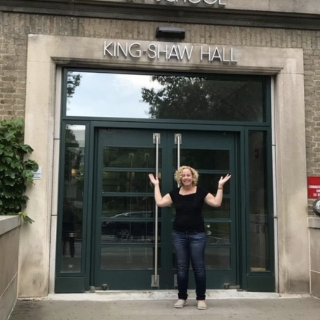 Person standing in front of a building's doors