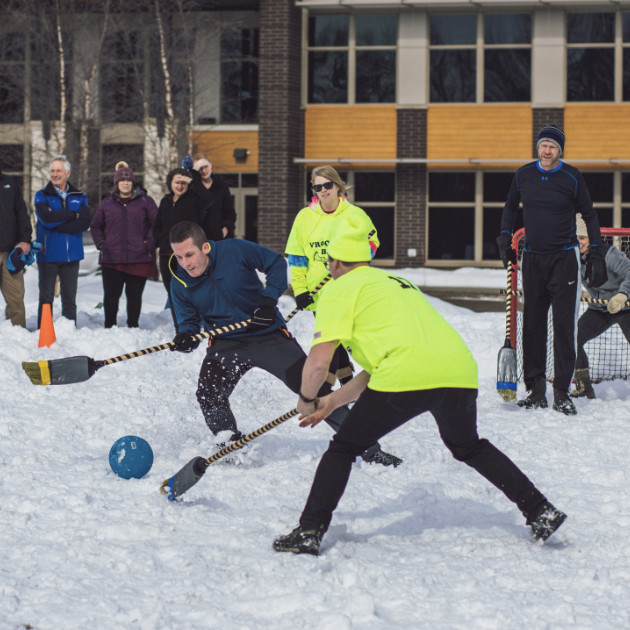 People playing broom hockey