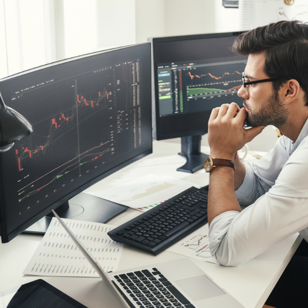 Person looking at a pair of computer screens