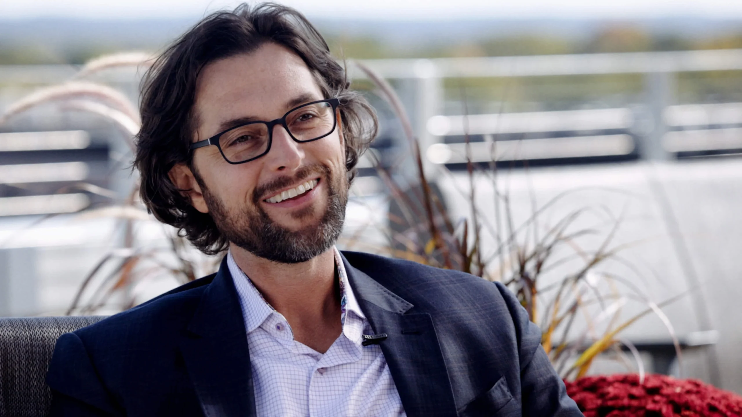 Smiling man in glasses outdoors