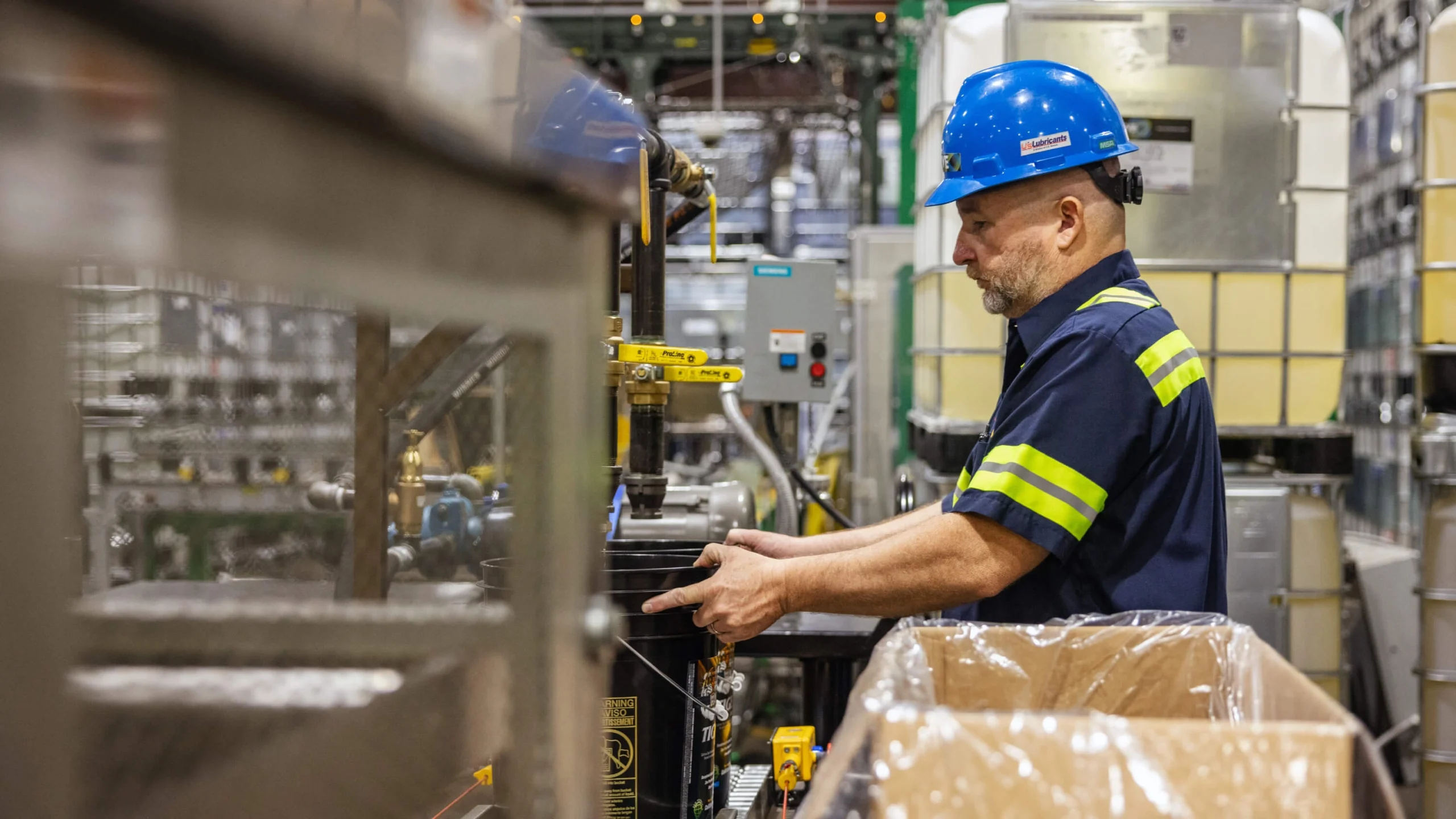Manufacturing team member operating equipment in production facility