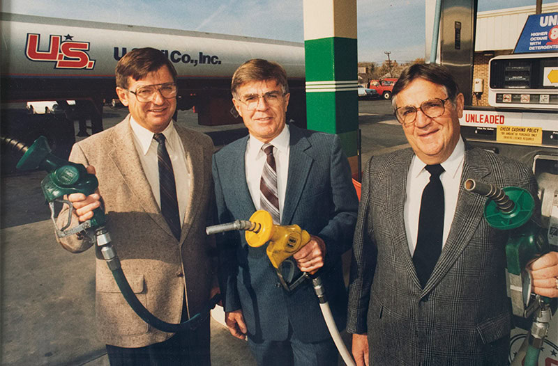 Vintage photo of three men with fuel nozzle