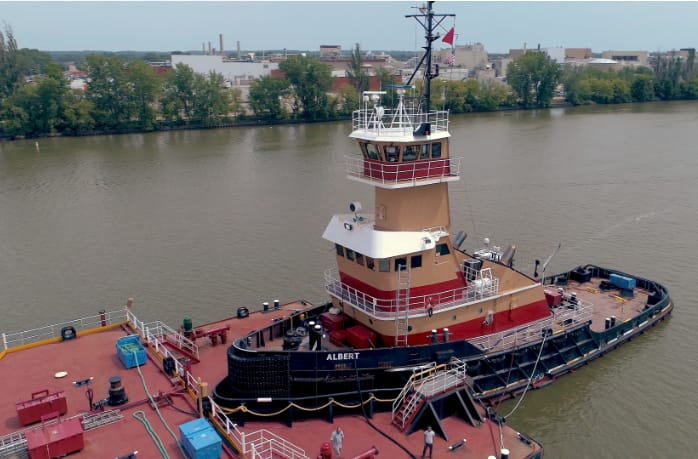 Red tugboat on waterway