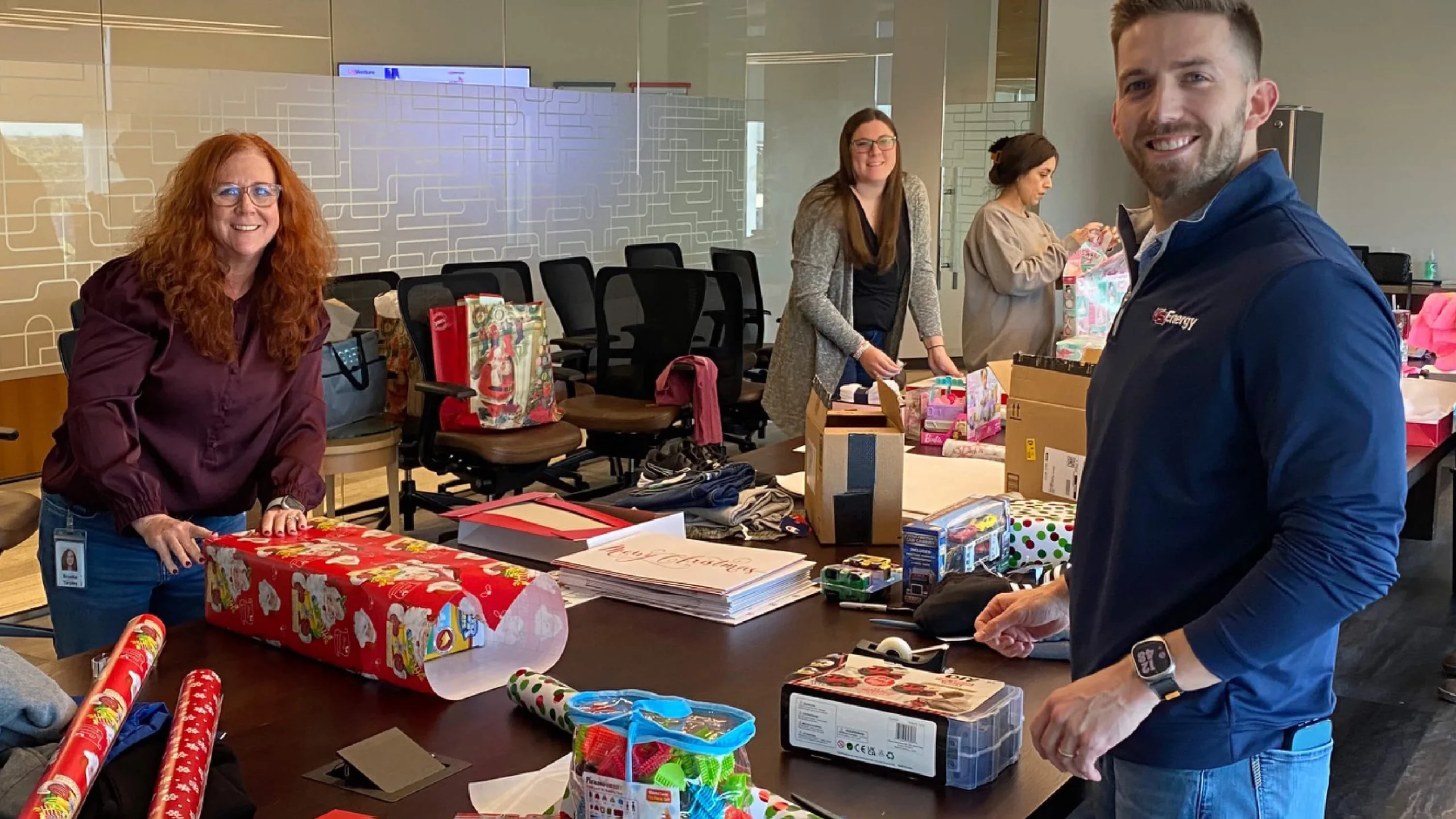 Employees assembling care packages or snacks for community drive