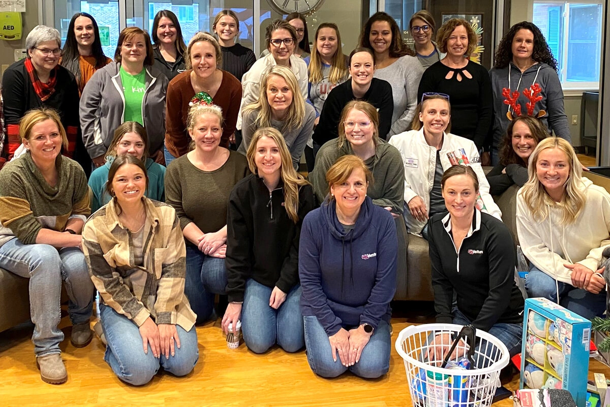 female team members gathered for group photo during company or community event