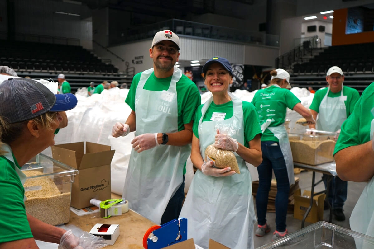 Team members packing rice at community service event