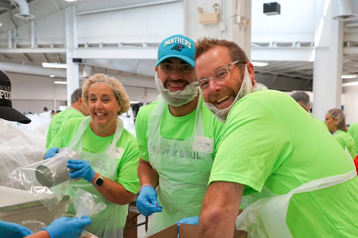 Group of volunteers in bright green shirts supporting hunger relief
