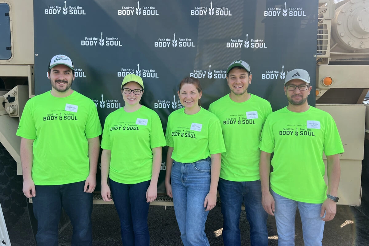 U.S. Venture volunteer team members in bright shirts posing after community service event