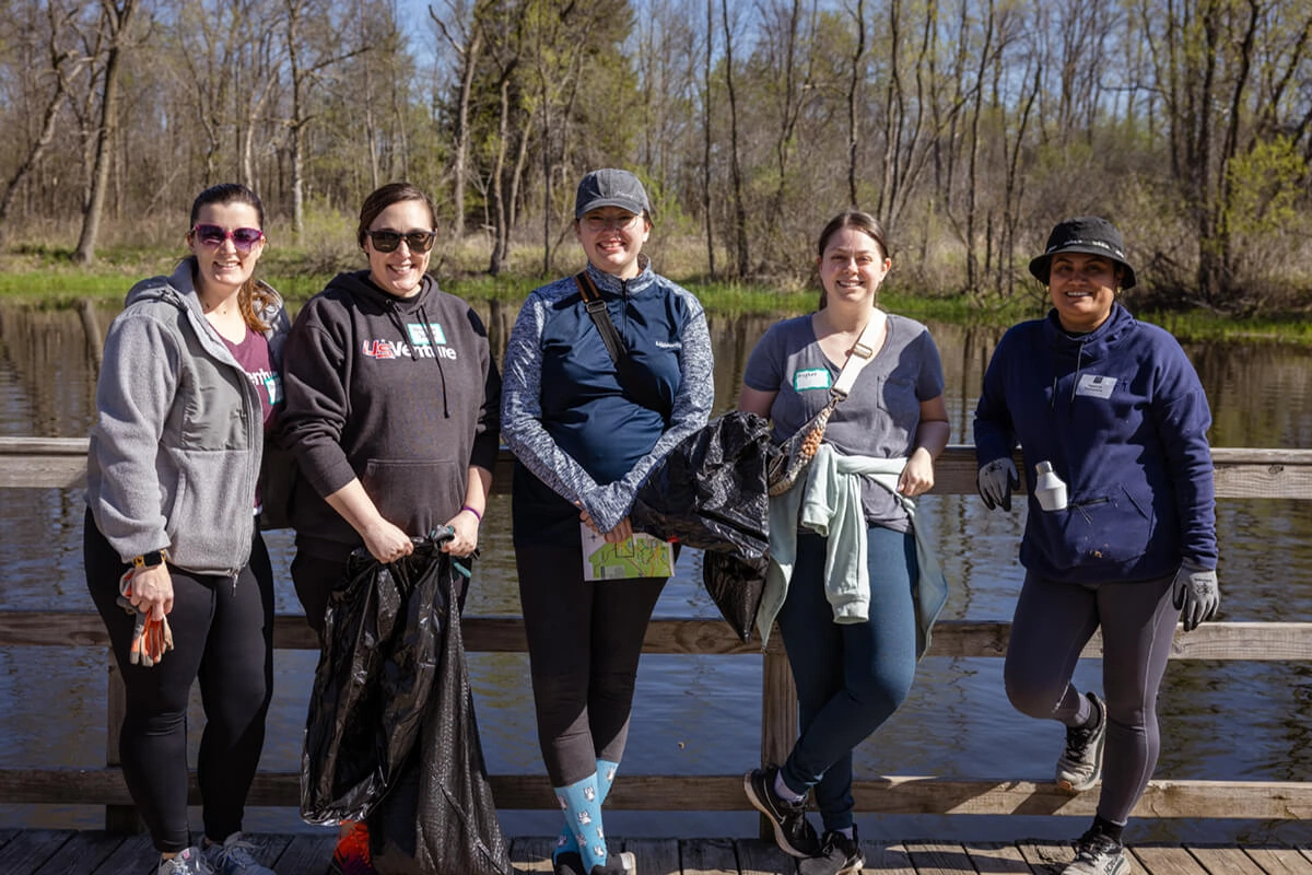 five female Employees participating in outdoor cleanup