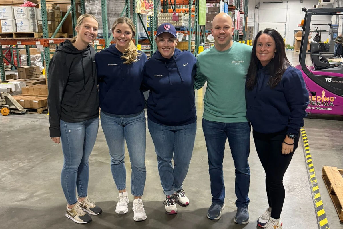Team members gathered for community service event in warehouse