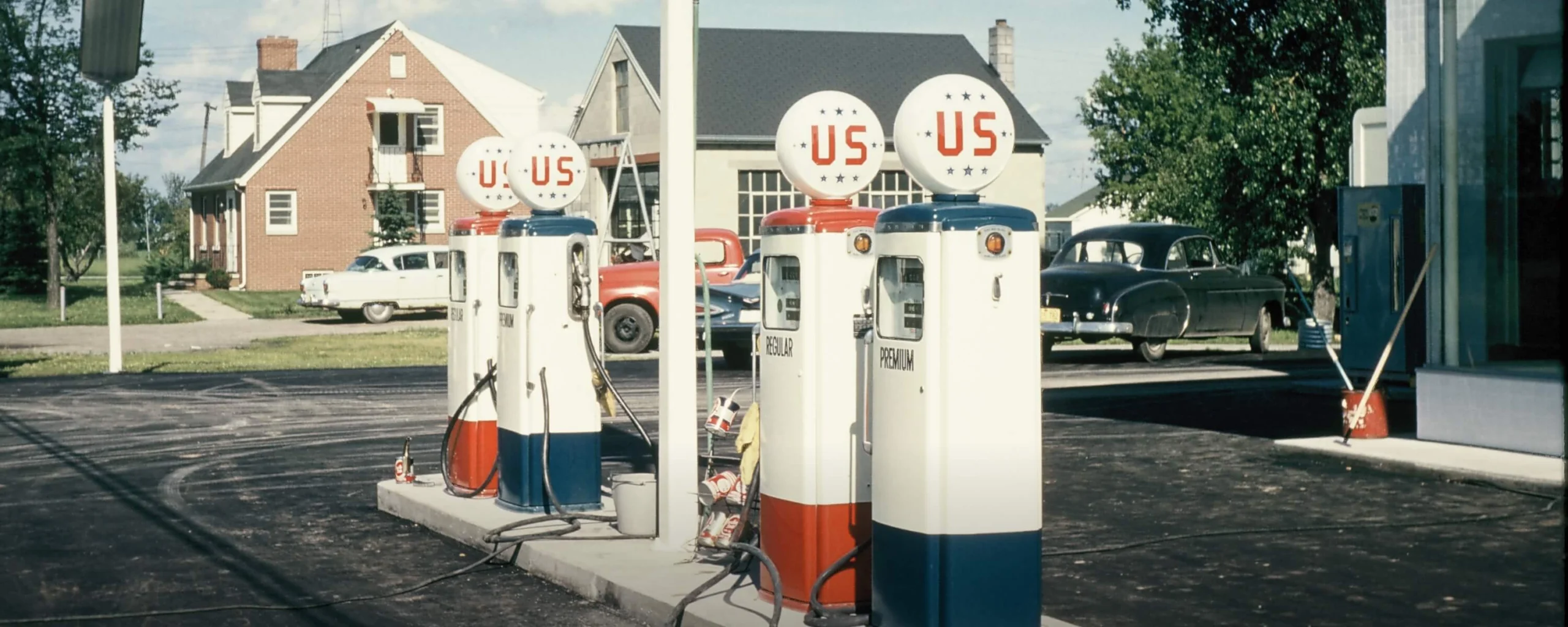 Historic U.S. Oil gasoline pumps outside early service station with retro branding