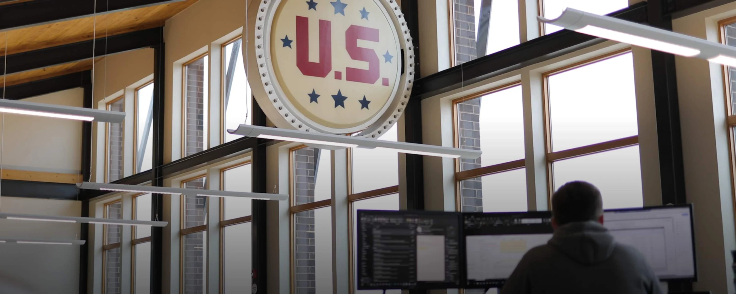 U.S. Venture interior decor showcasing company brand with man working on computer